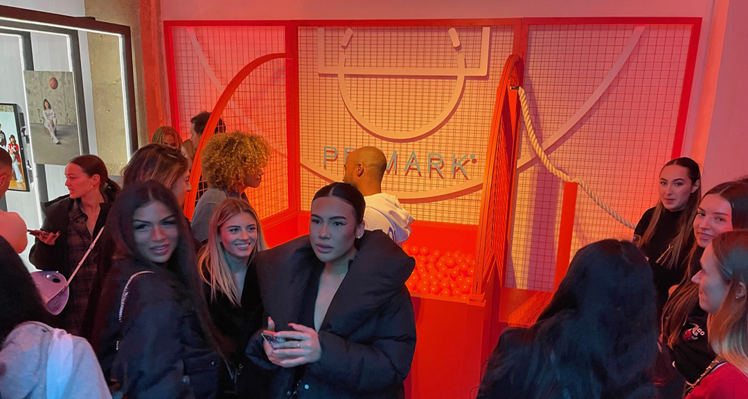 Influencers in front of the orange pool at the Primark Paris Event